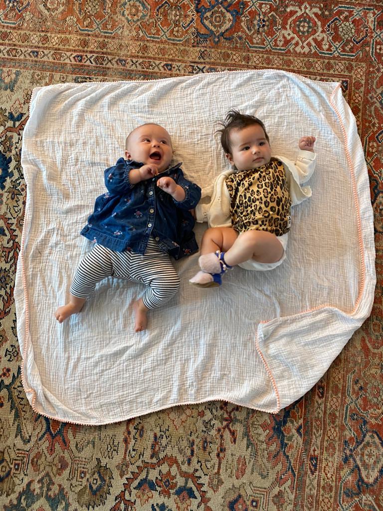 two babies on an ily baby peach swaddle